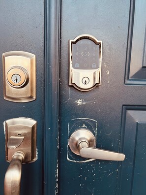 A door with a key lock, a numeric keypad, and a door handle.