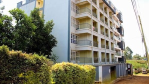 A multi-story residential building with balconies, surrounded by greenery. - Jiji poa (Nairobi)