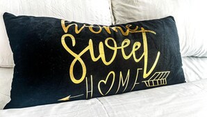 A black pillow with gold text on a white bedspread. - Jiji poa (Nairobi)