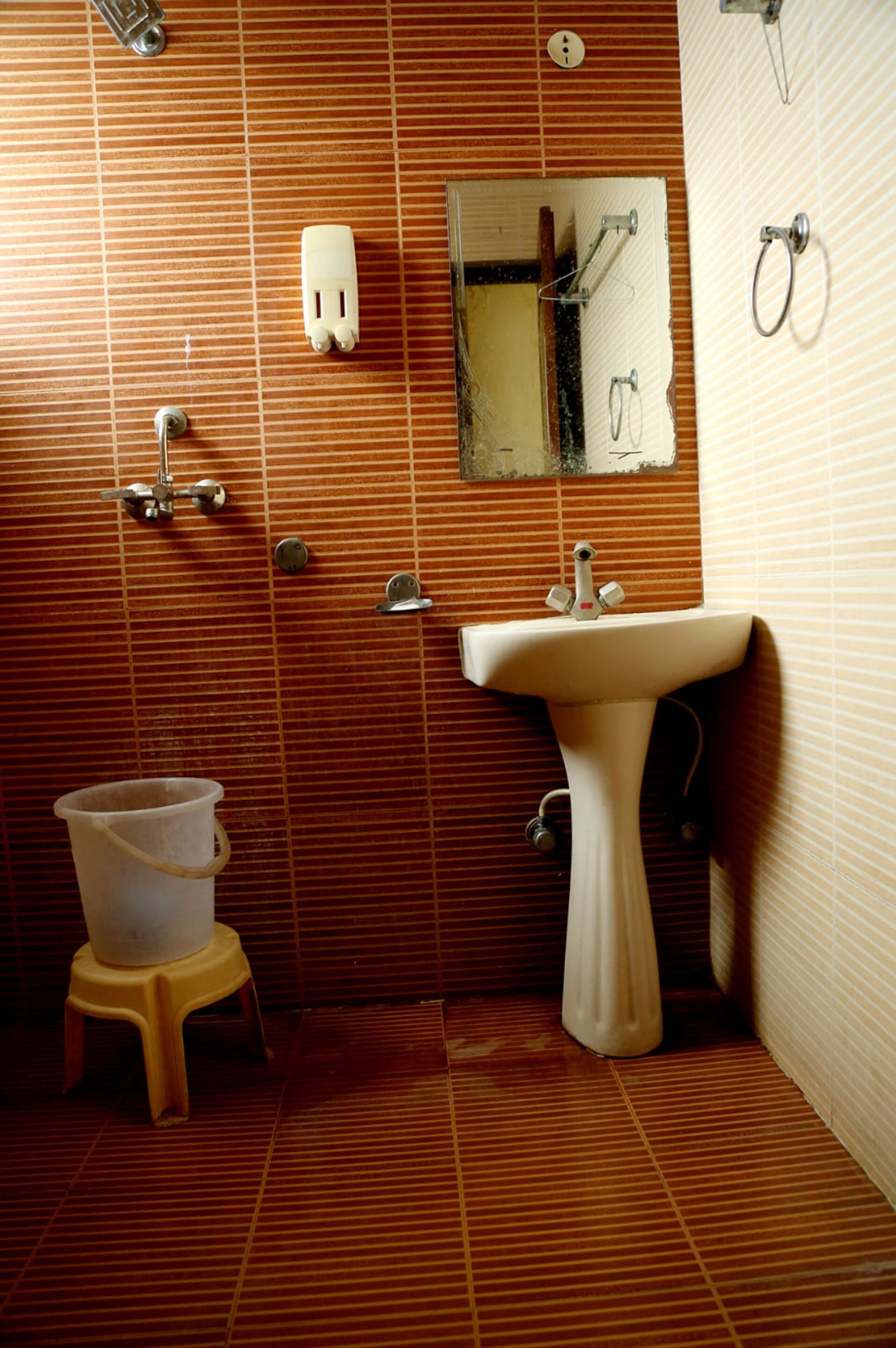 A bathroom with a sink, mirror, and toilet.