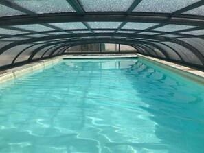 An indoor swimming pool with clear water, surrounded by a curved metal roof structure. - Spacious House with Private Pool and Garden in Saint Jean de Monts (Saint-Jean-de-Monts)