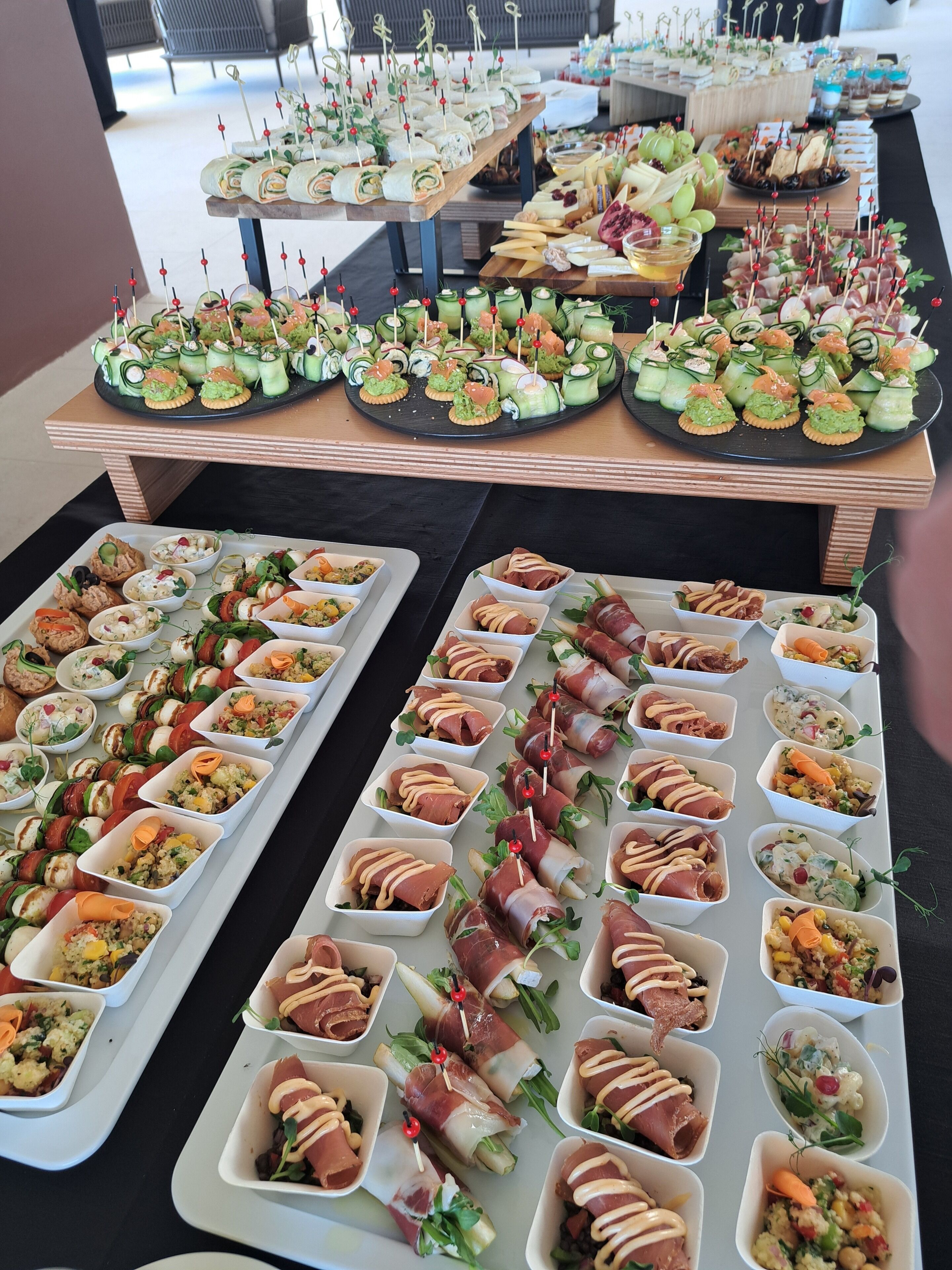 A buffet with various food items, including sandwiches, salads, and appetizers.