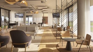 A spacious lounge area with modern furniture, large windows, and a view of the outdoors. - Hotel Materra (Cepin)
