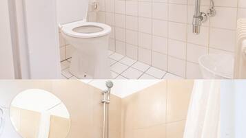 Departamento estándar | Baño | Tina con regadera y toallas