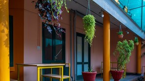 A yellow table and chairs outside a building with a door and windows. - La Courtyard  (Vanur)