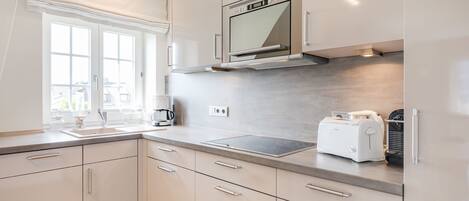 Fridge, stovetop, dishwasher, coffee/tea maker