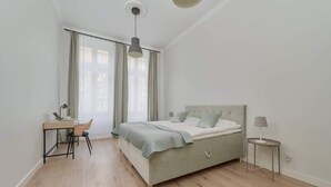 Une chambre à coucher avec un lit, un bureau et une chaise.