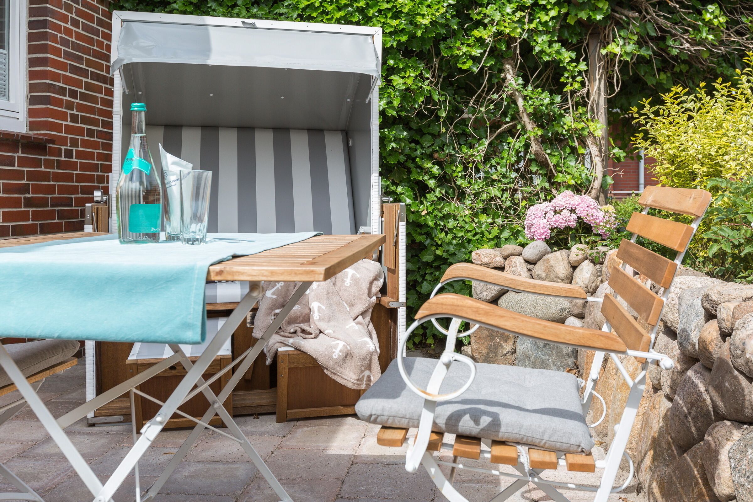 An outdoor seating area with a table, chairs, and a covered table.