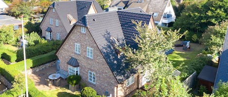 A residential area with houses featuring pitched roofs and brick exteriors.