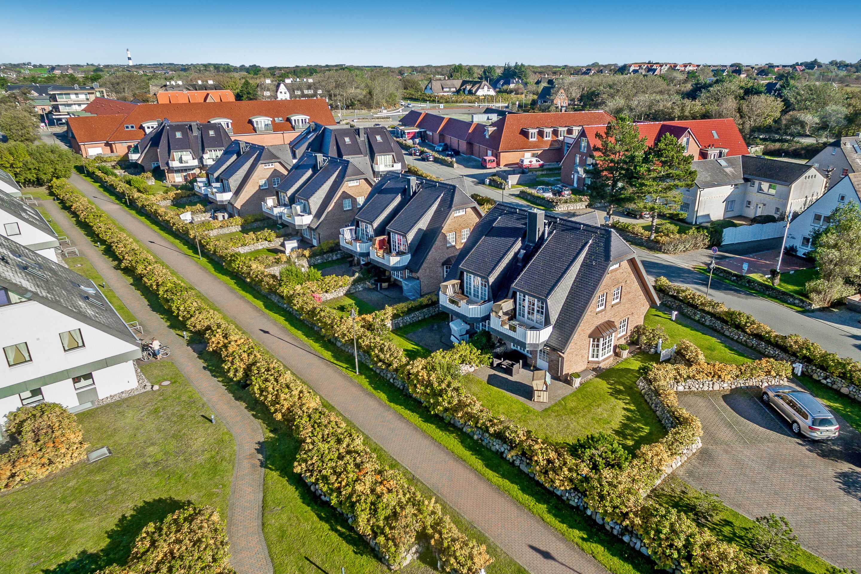 A residential area with houses featuring pitched roofs and attached garages.