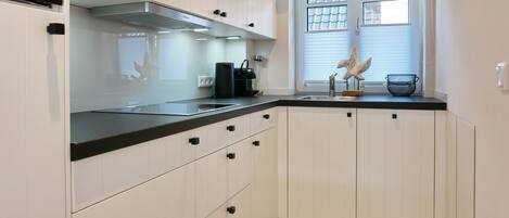 Fridge, stovetop, dishwasher, coffee/tea maker