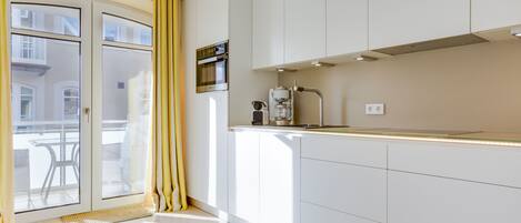 Fridge, stovetop, dishwasher, coffee/tea maker