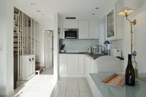 Fridge, stovetop, dishwasher, coffee/tea maker