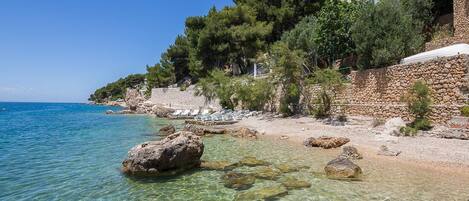 On the beach, sun-loungers, beach towels