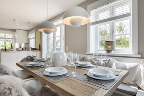 Enjoy a formal dining experience in this elegant space with a beautifully set table and serene views.