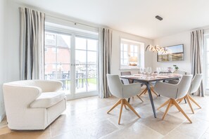 Enjoy meals with friends and family in this spacious dining area, featuring a large table and six comfortable chairs.