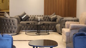 A modern living room with a sectional sofa, two armchairs, and a coffee table. - Ardos Park Hotel (Ankara)