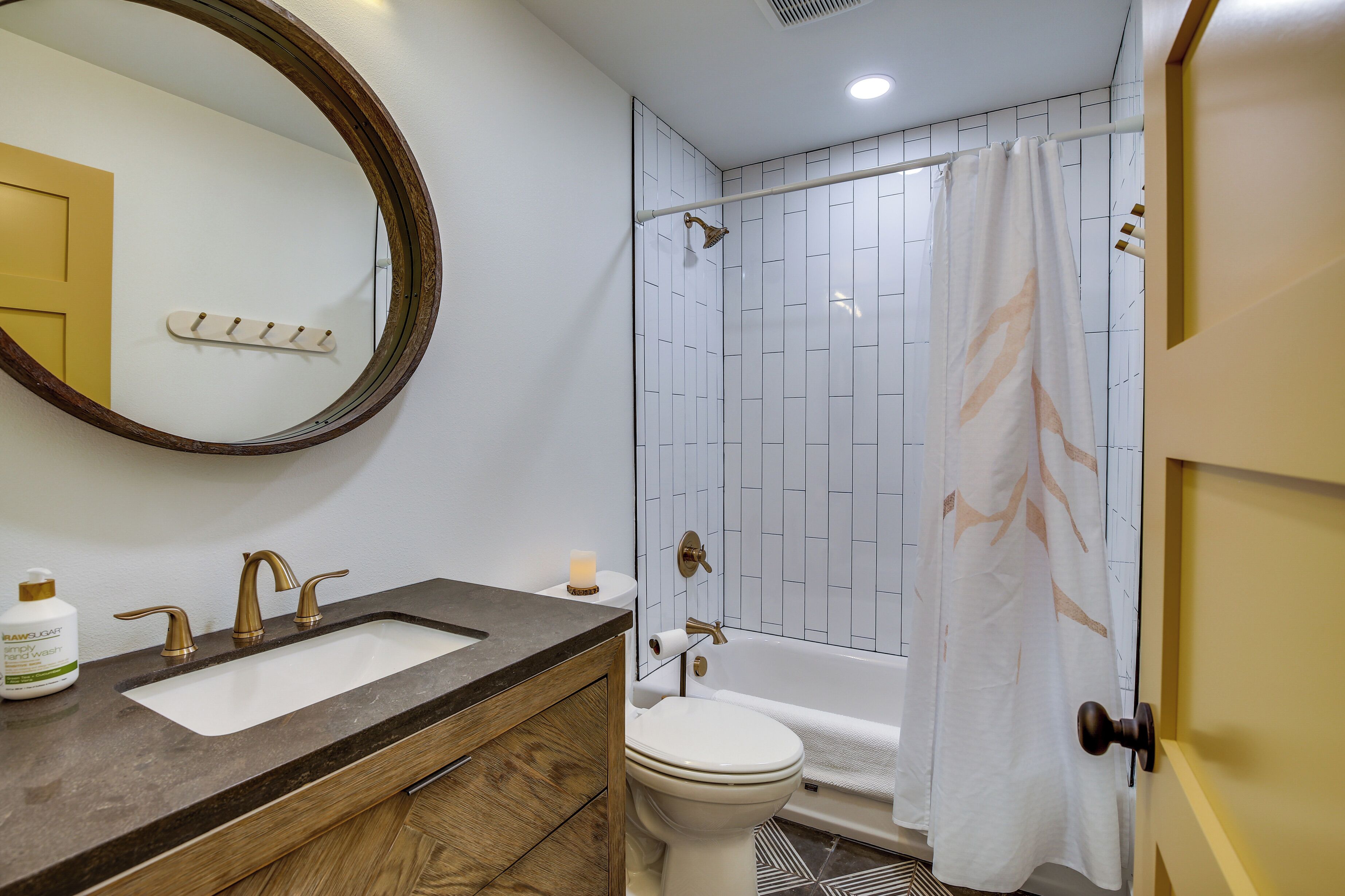 A bathroom with a sink, toilet, and shower.