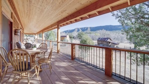 A wooden deck with a table and chairs, overlooking a mountainous landscape. - 'lavender Lodge' Mountain-view Pine Cabin w/ Deck (Pine)
