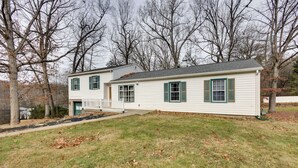A two-story house with a front porch, a small front yard, and a driveway. - Charming State College Home - 4 Mi to Psu! (State College)