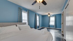 A bedroom with a bed, a ceiling fan, and patterned curtains. - Charming State College Home - 4 Mi to Psu! (State College)