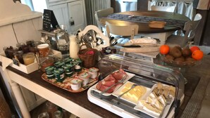 A breakfast buffet with various food items, including pastries, meats, and fruits. - Domaine du Moulin (Saint-Avold)