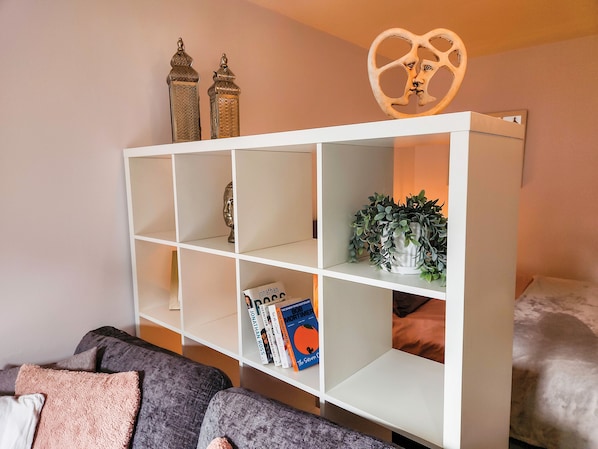 A white bookshelf with decorative items and books. - Portway Nook - 1 Bed Studio - Bishopston (Swansea)
