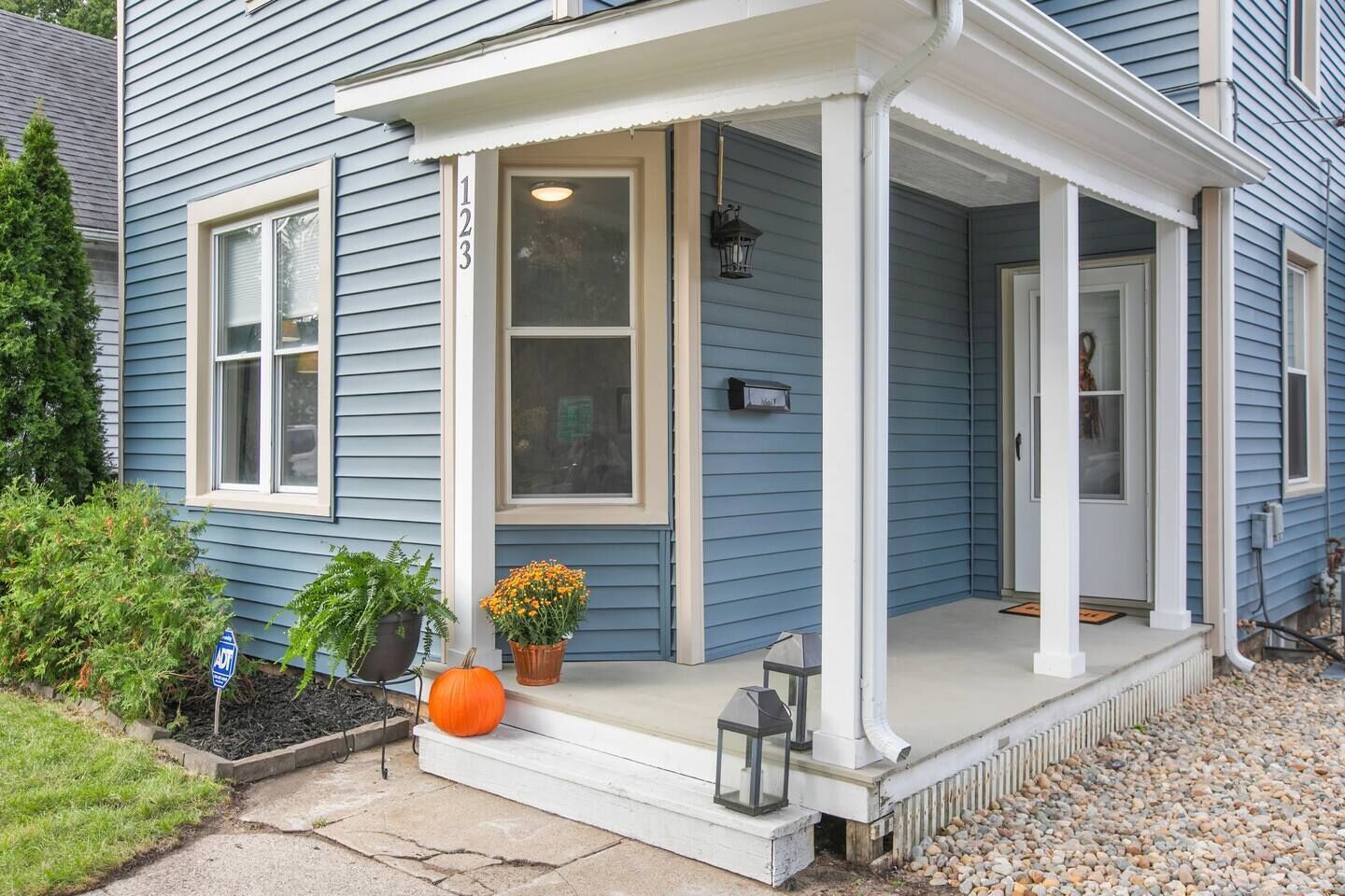 A house with a porch, a mailbox, and a door.