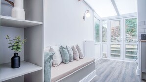 A modern interior with a bench, shelves, and a skylight. - Castle Square - 2 Bedroom - Mumbles (Swansea)