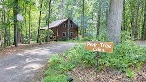 A cabin labeled "Pear Tree Cabin" surrounded by a forest.