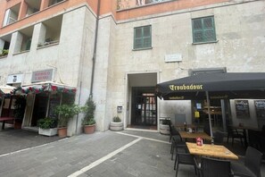 A street with outdoor seating at a café.