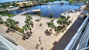 A waterfront area with a dock, palm trees, and a circular seating area. - LTW 421 in PCB! Beautiful Views 3 Bed 3 Bath Sleeps 8 (Panama City Beach)