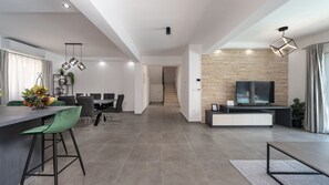A modern living space with a dining area, kitchen, and entertainment area. - Villa Danica by Villas Guide (Bibinje)