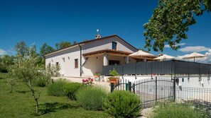 A two-story house with a balcony, surrounded by greenery and a gated entrance. - Villa Bibali Istra by Villas Guide (Bibali)