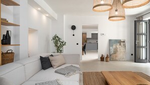 A modern living room with a white sofa, a wooden coffee table, and wicker lamps. - Villa Molindrio by Villas Guide (Porec)