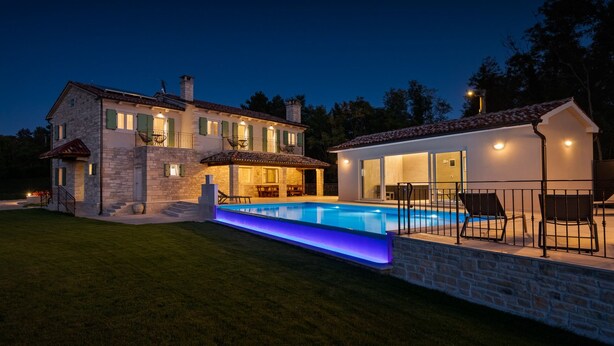 A two-story stone house with a swimming pool, outdoor seating, and a well-lit patio area. - Villa Kave by Villas Guide (Grožnjan)