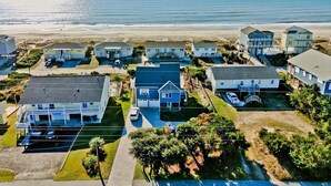 A coastal residential area with houses, a beach, and a clear view of the ocean. - Dark and Stormy, Almost Oceanfront House in Emerald Isle, NC! (Emerald Isle)