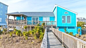 A two-story house with a wooden deck and a blue exterior. - Dune Alright, Oceanfront House in Emerald Isle, NC! (Emerald Isle)