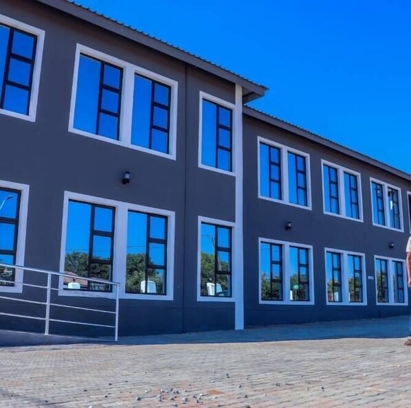 A modern building with multiple windows and a flat roof.