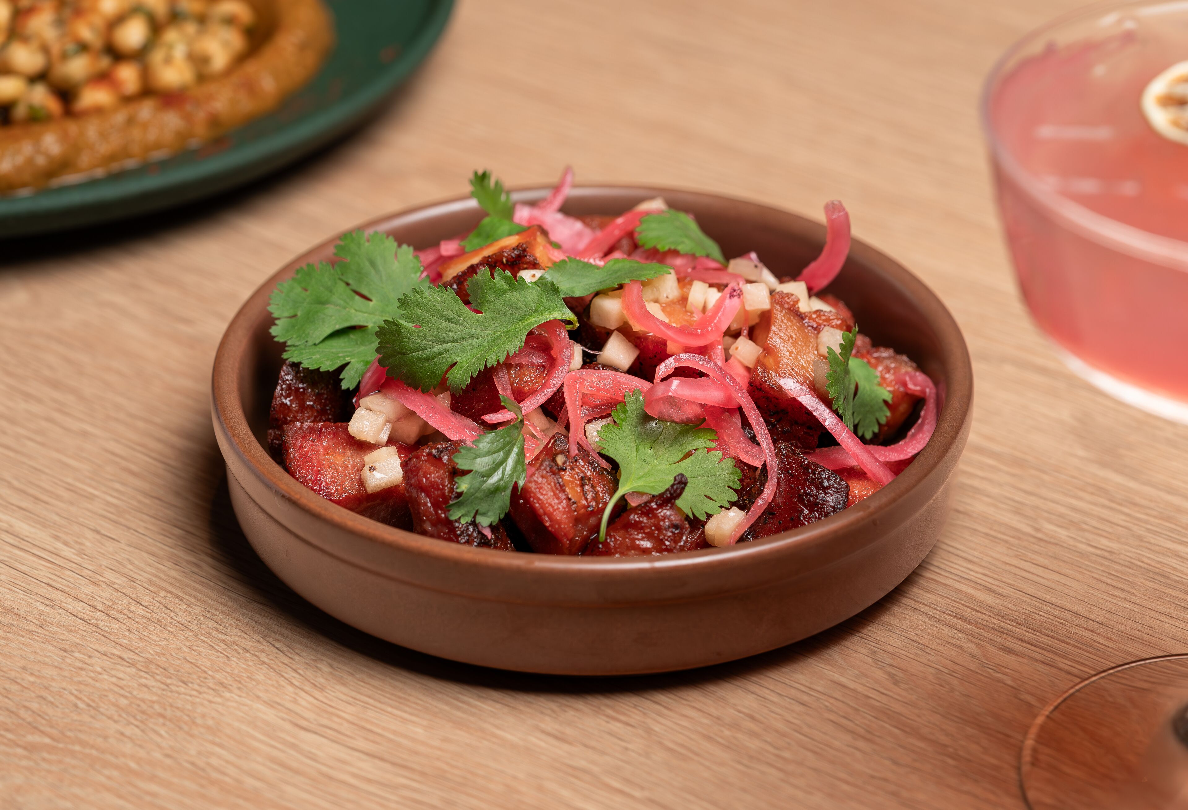A bowl of food with diced vegetables and herbs.