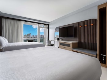 In-room safe, desk, laptop workspace, blackout drapes at Hilton Garden Inn San Juan Condado