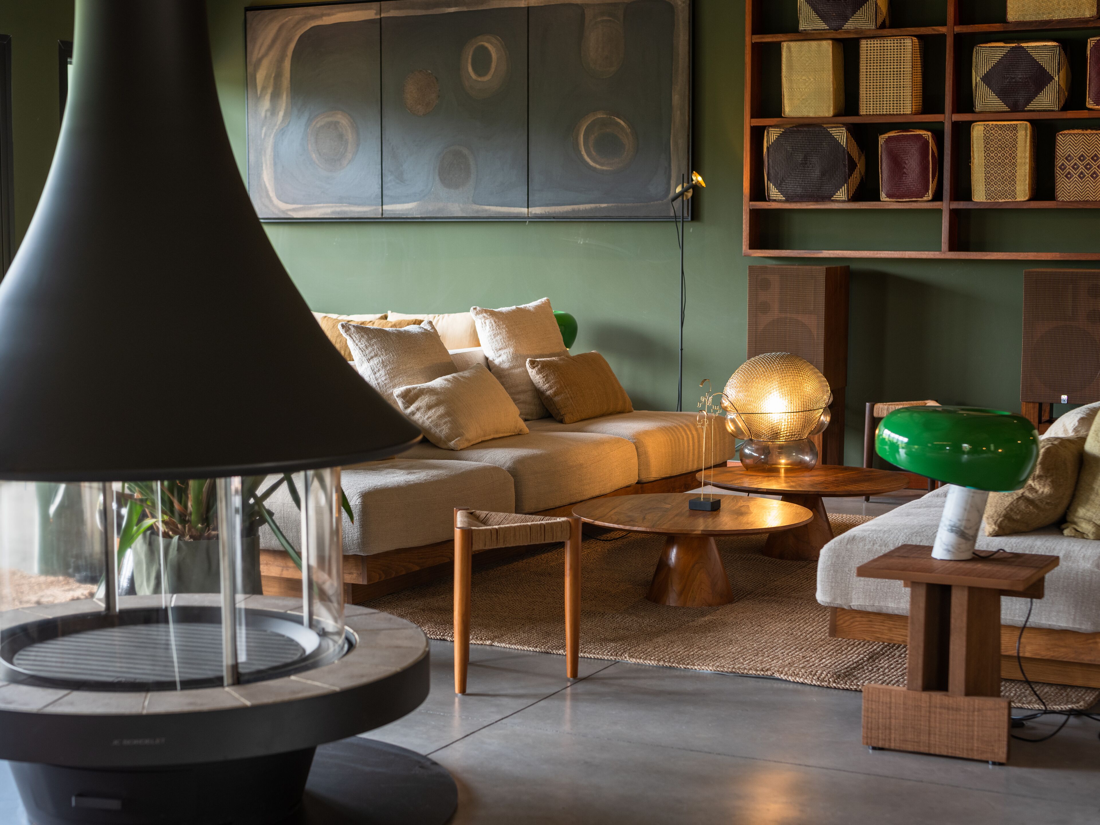 A modern living room with a round coffee table, a sofa, and a large floor lamp.