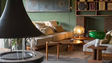 A modern living room with a round coffee table, a sofa, and a large floor lamp.