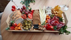 A charcuterie board with various cheeses, meats, fruits, and nuts. - Harriette's Guest House (Blackpool)