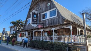 A rustic wooden building with a sign reading "Barn 34." - Newly remodeled with ocean views! Steps to the beach in the heart of midtown OC! (Ocean City)