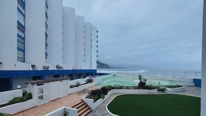 A hotel with a pool area, a staircase leading to the entrance, and a view of the ocean. - Sunset with views of Teide (Mesa del Mar)