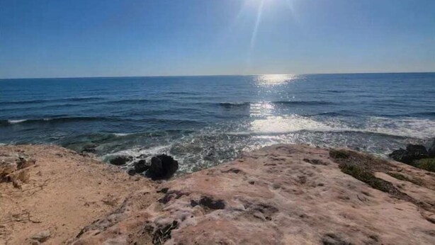 A beach with clear skies and sunlight reflecting on the water. - Condo on the Caribbean (Isla Mujeres)