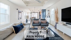 A spacious main house with a large living area, a dining area, and a kitchen. - Contemporary East Austin Home + Separate Backyard Loft on Fenced-In Property (Austin)