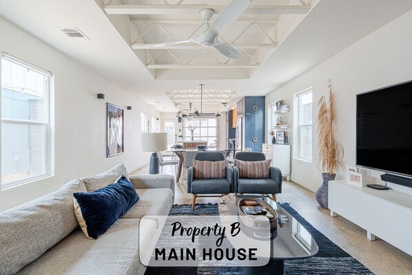 A spacious main house with a large living area, a dining area, and a kitchen.