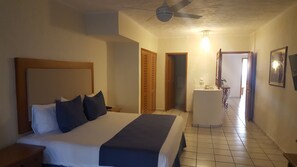 Relax in comfort with a large bed, desk, and mirror in this well-appointed room.